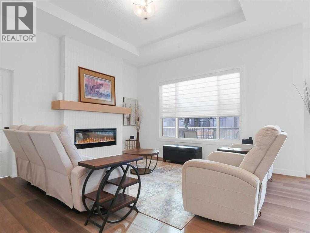 110 Sunstone Way, Balzac, AB - Indoor Photo Showing Living Room With Fireplace