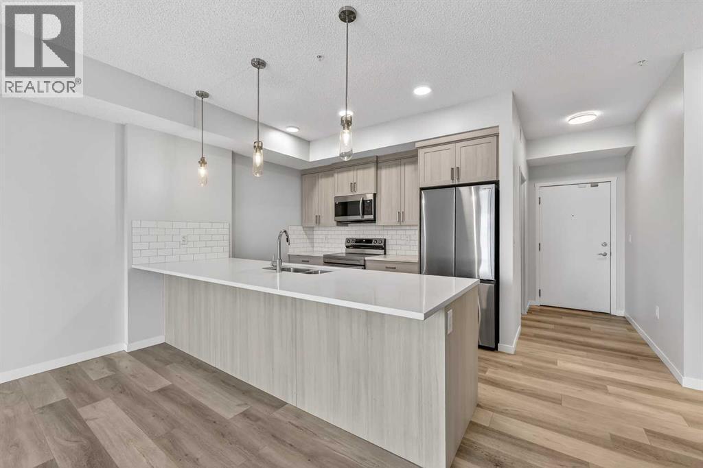 1410, 33 Carringham Gate Nw, Calgary, AB - Indoor Photo Showing Kitchen With Stainless Steel Kitchen With Upgraded Kitchen