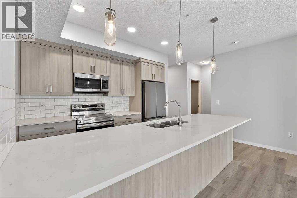 1410, 33 Carringham Gate Nw, Calgary, AB - Indoor Photo Showing Kitchen With Stainless Steel Kitchen With Double Sink With Upgraded Kitchen