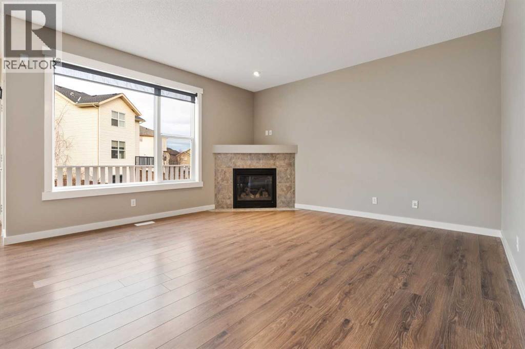 327 Panamount Point Nw, Calgary, AB - Indoor Photo Showing Living Room With Fireplace