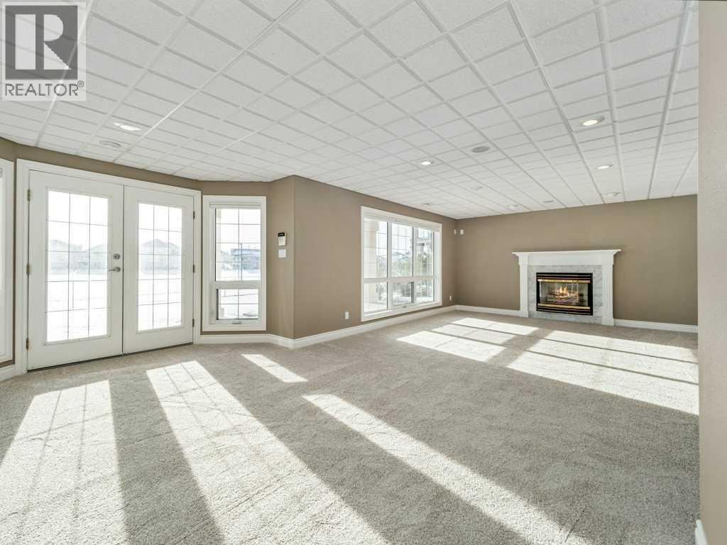 24 Fairmont Point S, Lethbridge, AB - Indoor Photo Showing Other Room With Fireplace