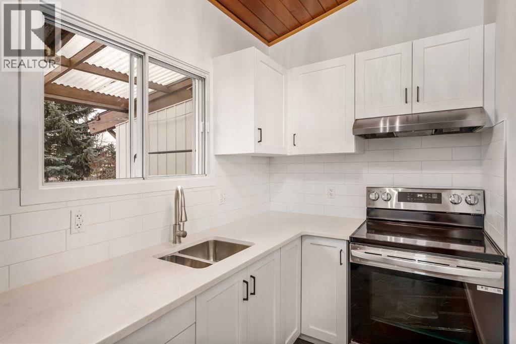 15 A Arlington Bay Se, Calgary, AB - Indoor Photo Showing Kitchen With Double Sink