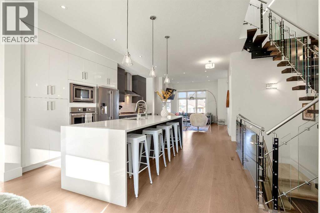 Large Island W/ Waterfall Quartz Countertop - 303 30 Avenue Ne, Calgary, AB - Indoor Photo Showing Kitchen With Upgraded Kitchen