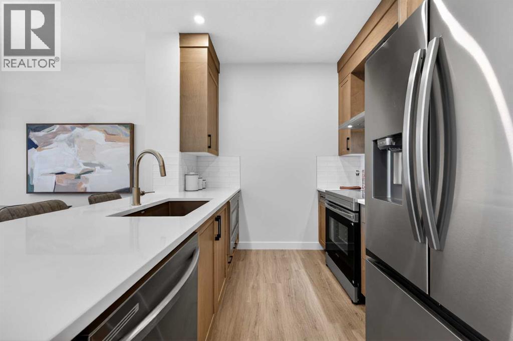 1051 Bayview Crescent, Airdrie, AB - Indoor Photo Showing Kitchen With Stainless Steel Kitchen With Upgraded Kitchen