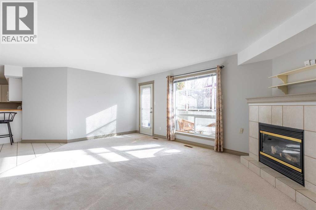 314, 23 Chilcotin Lane W, Lethbridge, AB - Indoor Photo Showing Living Room With Fireplace
