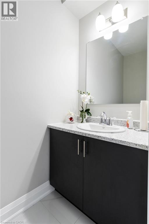 Bathroom featuring vanity and light tile patterned flooring - 24 Tamarack Way, Simcoe, ON - Indoor Photo Showing Bathroom