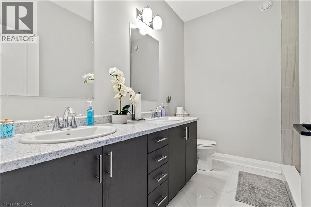 Full bathroom with double vanity and a shower - 24 Tamarack Way, Simcoe, ON - Indoor Photo Showing Bathroom