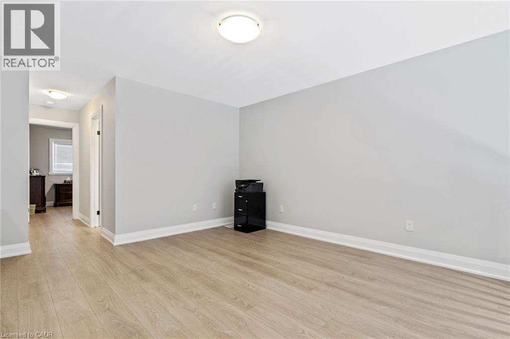Empty room featuring baseboards and light wood finished floors - 24 Tamarack Way, Simcoe, ON - Indoor Photo Showing Other Room