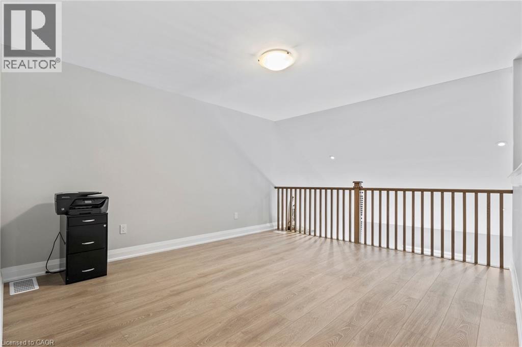 Empty room with light wood-type flooring and baseboards - 24 Tamarack Way, Simcoe, ON - Indoor Photo Showing Other Room