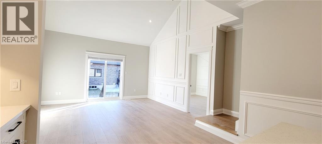 light wood-style flooring, ornamental molding, and recessed lighting - 24 Tamarack Way, Simcoe, ON - Indoor Photo Showing Other Room