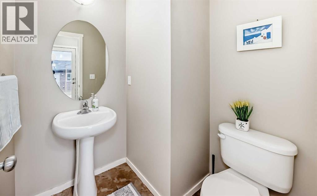 2 piece bath close to the back entrance - 822 Panatella Boulevard Nw, Calgary, AB - Indoor Photo Showing Bathroom