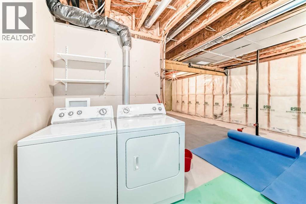 Laundry in basement - 822 Panatella Boulevard Nw, Calgary, AB - Indoor Photo Showing Laundry Room