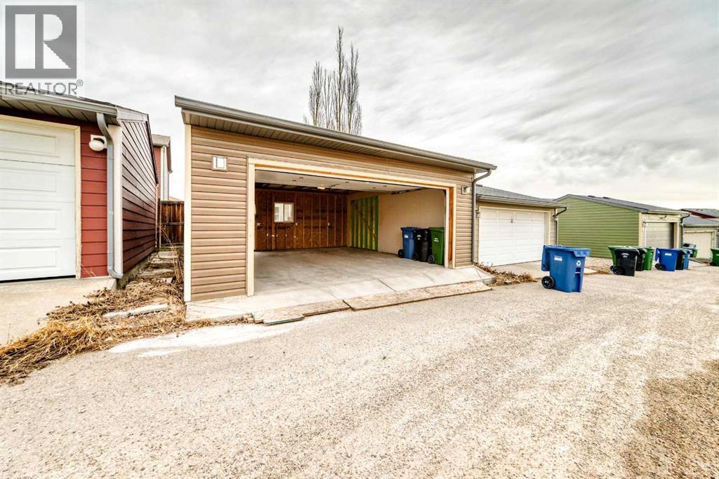 over sized double garage, fit in 2 trucks - 822 Panatella Boulevard Nw, Calgary, AB - Outdoor With Exterior