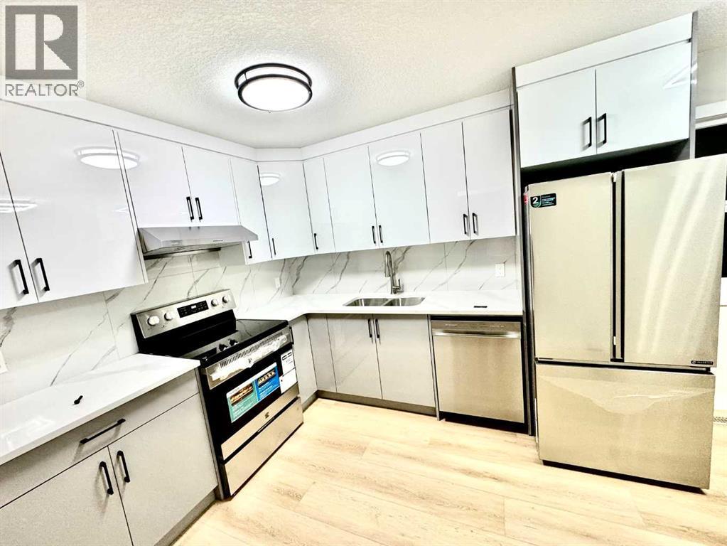 7616 27 Street Se, Calgary, AB - Indoor Photo Showing Kitchen With Stainless Steel Kitchen With Double Sink