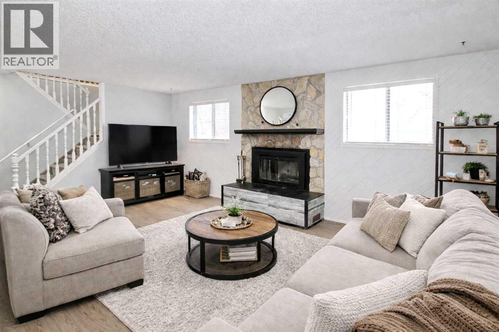 virtually staged - 97 Cunningham Crescent, Red Deer, AB - Indoor Photo Showing Living Room With Fireplace