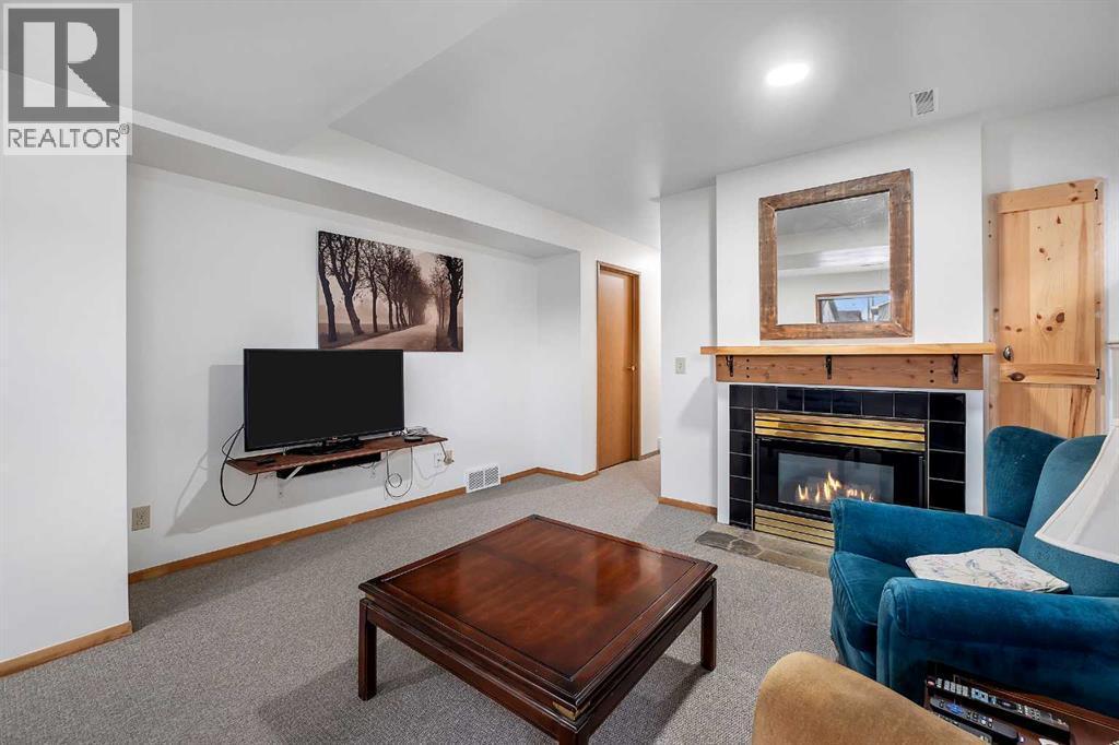 192 Rivercrest Close Se, Calgary, AB - Indoor Photo Showing Living Room With Fireplace