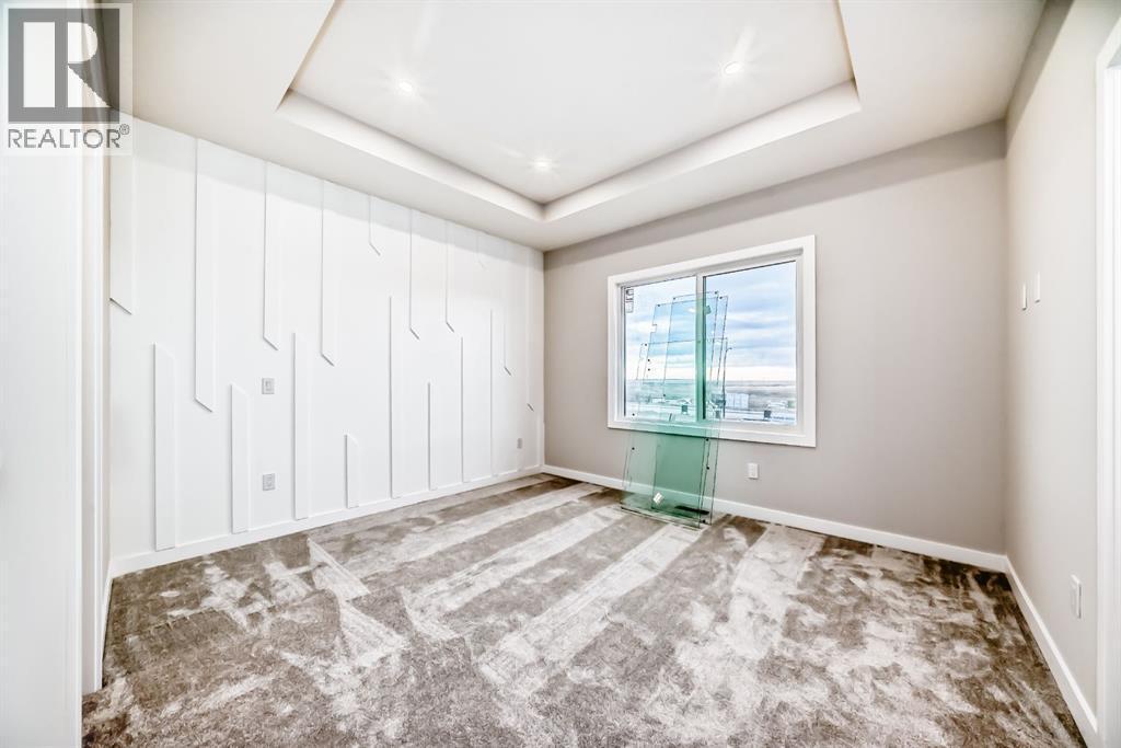 Primary bedroom with Tray ceiling - 508 Heritage Boulevard, Cochrane, AB - Indoor Photo Showing Other Room
