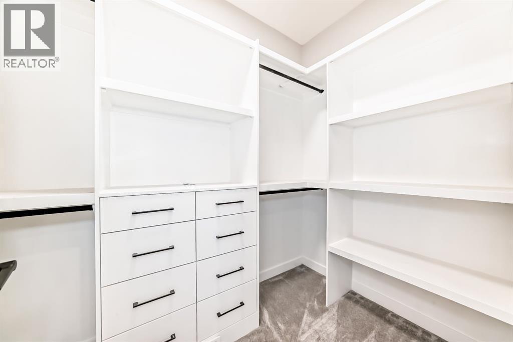 Primary bedroom walk in closet - 508 Heritage Boulevard, Cochrane, AB - Indoor