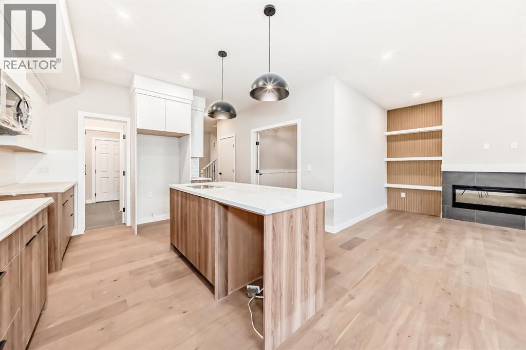 508 Heritage Boulevard, Cochrane, AB - Indoor Photo Showing Kitchen With Fireplace