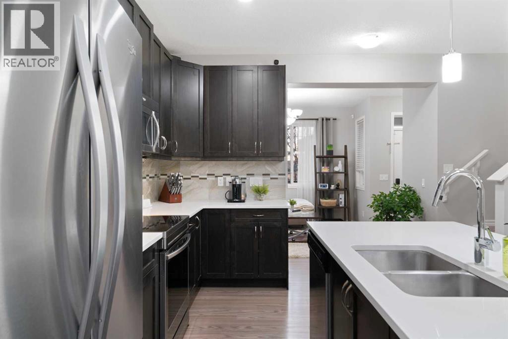 1529 Legacy Circle Se, Calgary, AB - Indoor Photo Showing Kitchen With Stainless Steel Kitchen With Double Sink With Upgraded Kitchen