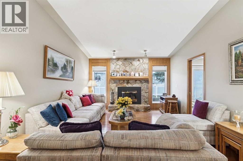 1025 Shawnee Road Sw, Calgary, AB - Indoor Photo Showing Living Room With Fireplace