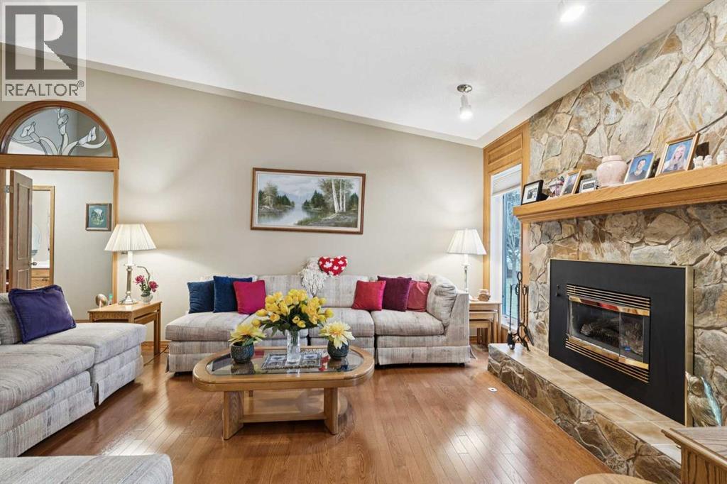 1025 Shawnee Road Sw, Calgary, AB - Indoor Photo Showing Living Room With Fireplace