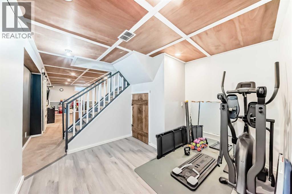 fitness nook - 12 Taraglen Road Ne, Calgary, AB - Indoor Photo Showing Gym Room