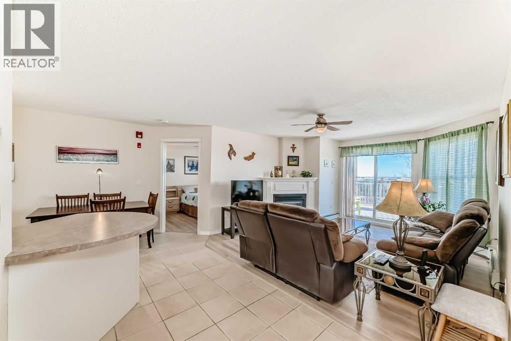 111, 6900 Hunterview Drive Nw, Calgary, AB - Indoor Photo Showing Living Room With Fireplace