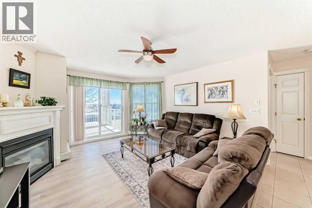 111, 6900 Hunterview Drive Nw, Calgary, AB - Indoor Photo Showing Living Room With Fireplace