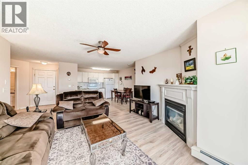 111, 6900 Hunterview Drive Nw, Calgary, AB - Indoor Photo Showing Living Room With Fireplace