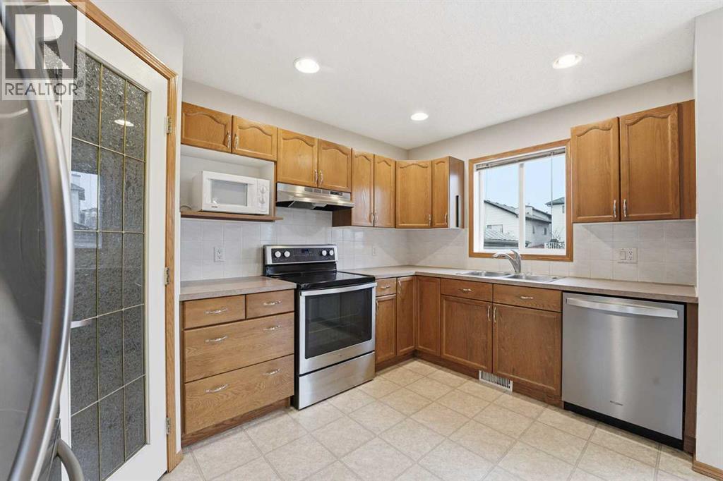 905 Arbour Lake Road Nw, Calgary, AB - Indoor Photo Showing Kitchen With Stainless Steel Kitchen With Double Sink