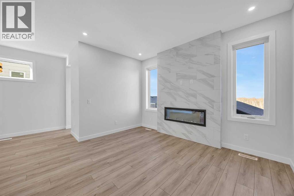 26 Versant Path Sw, Calgary, AB - Indoor With Fireplace
