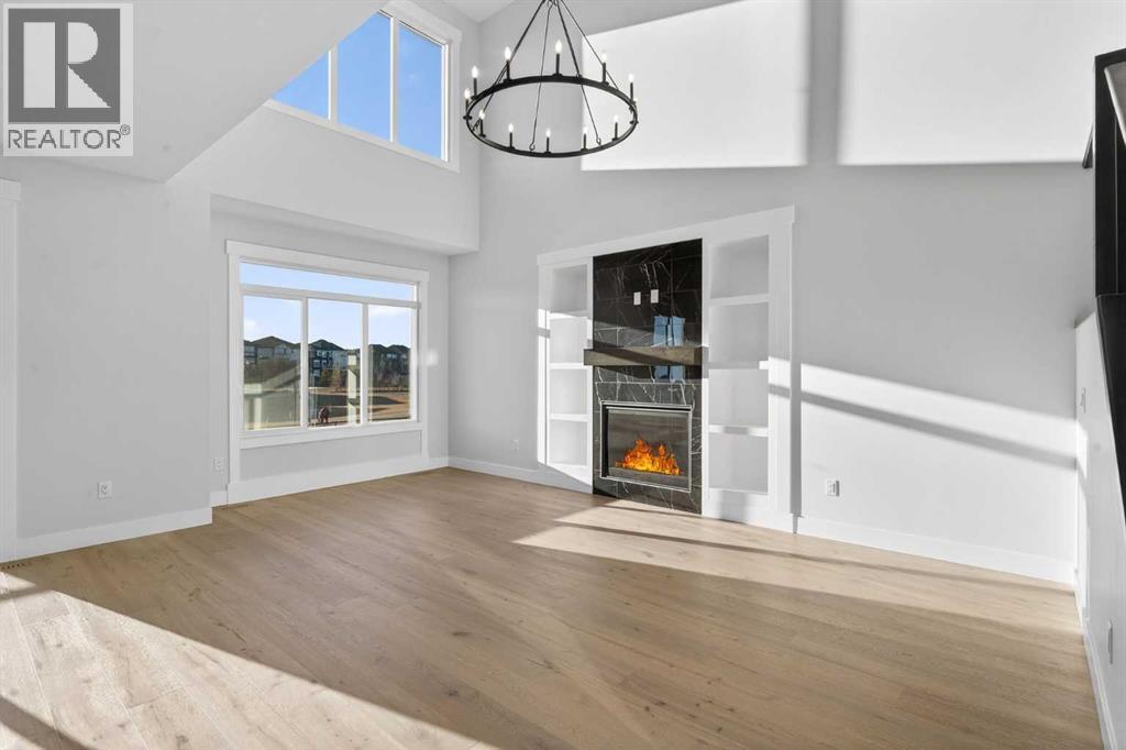 202 Kinniburgh Loop, Chestermere, AB - Indoor Photo Showing Other Room With Fireplace