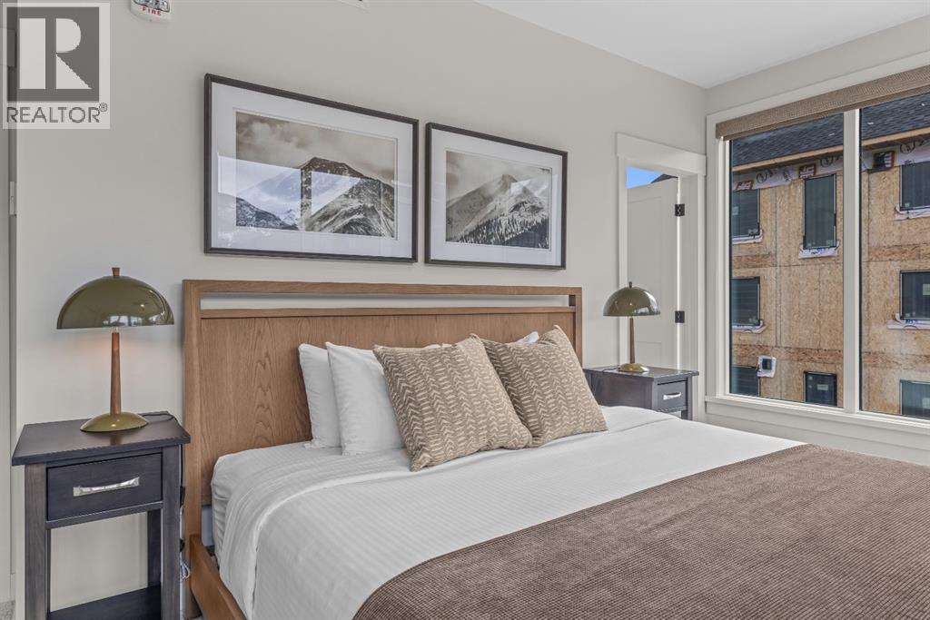 Primary bedroom #2 - 313, 1408 Spring Creek Gate, Canmore, AB - Indoor Photo Showing Bedroom