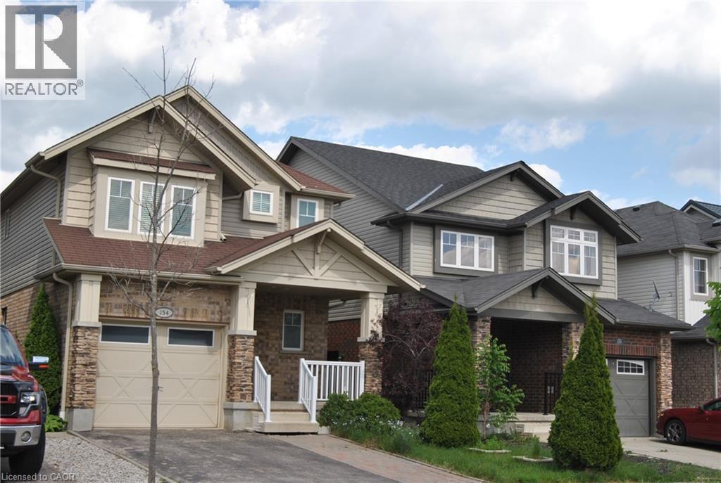 Craftsman inspired home with covered porch, an attached garage, driveway, and a shingled roof - 154 Harding Street, Kitchener, ON - Outdoor With Facade