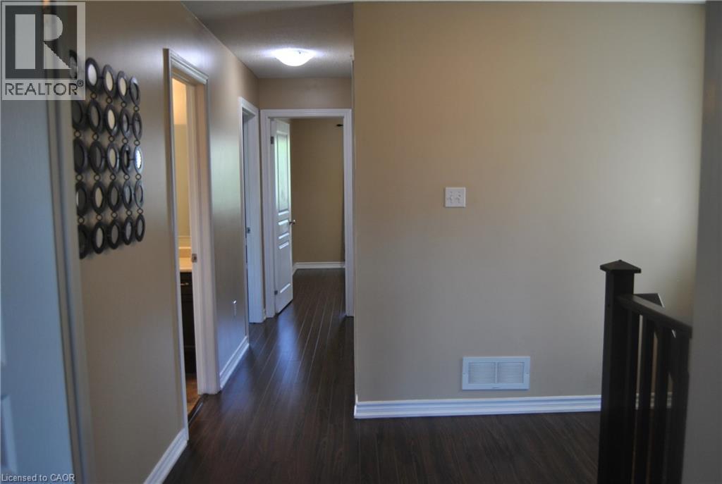 Corridor featuring dark wood-type flooring and an upstairs landing - 154 Harding Street, Kitchener, ON - Indoor Photo Showing Other Room