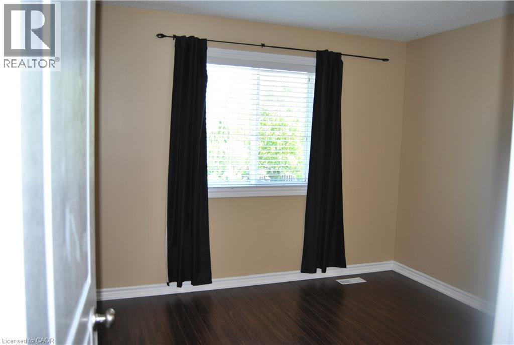 Spare room with baseboards and dark wood-style flooring - 154 Harding Street, Kitchener, ON - Indoor Photo Showing Other Room