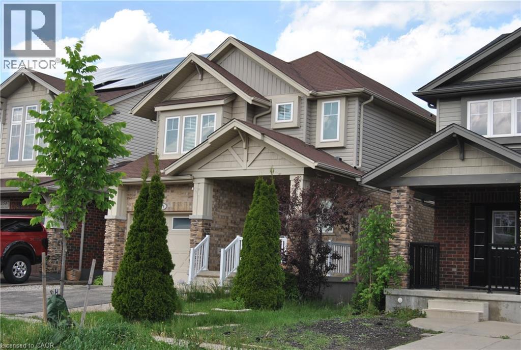 Craftsman-style house featuring a porch, brick siding, stone siding, and board and batten siding - 154 Harding Street, Kitchener, ON - Outdoor With Facade