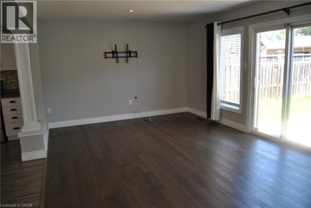 Unfurnished dining area featuring dark wood-type flooring, decorative columns, and recessed lighting - 154 Harding Street, Kitchener, ON - Indoor Photo Showing Other Room