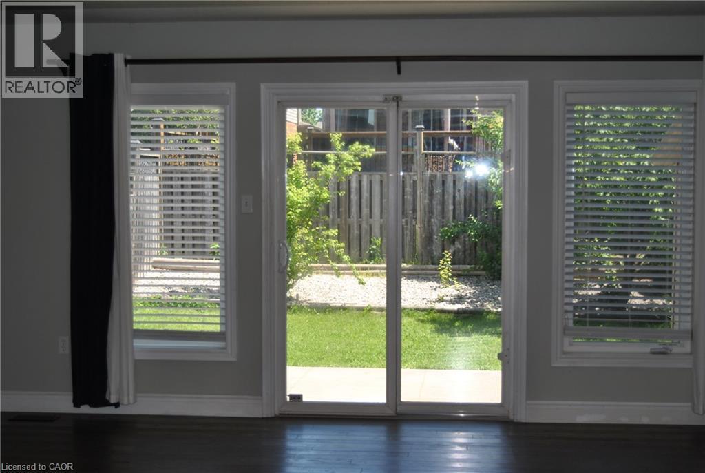 Doorway with baseboards and wood finished floors - 154 Harding Street, Kitchener, ON - Indoor Photo Showing Other Room