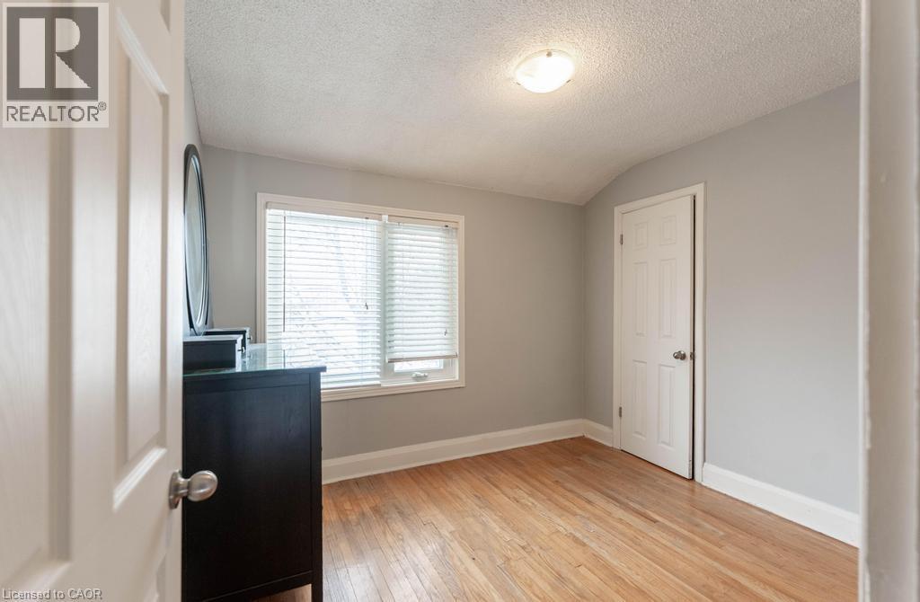 Office area featuring baseboards, vaulted ceiling, a textured ceiling, and light wood finished floors - 854 West 5Th Street, Hamilton, ON - Indoor Photo Showing Other Room