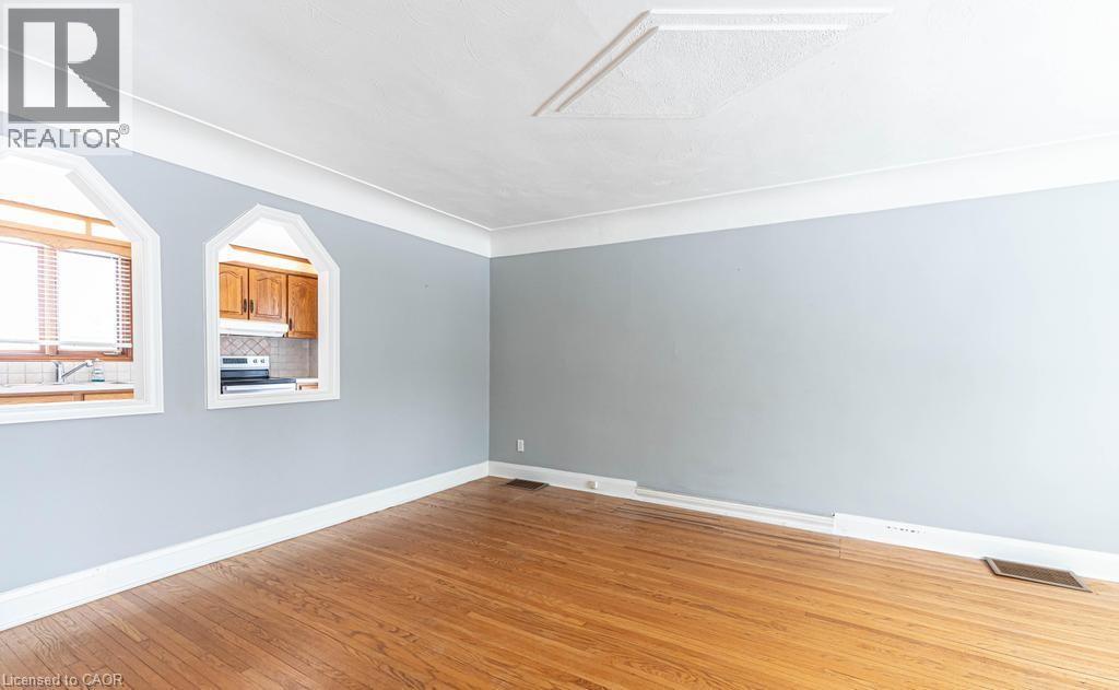 Empty room featuring visible vents, light wood-style flooring, and baseboards - 854 West 5Th Street, Hamilton, ON - Indoor Photo Showing Other Room