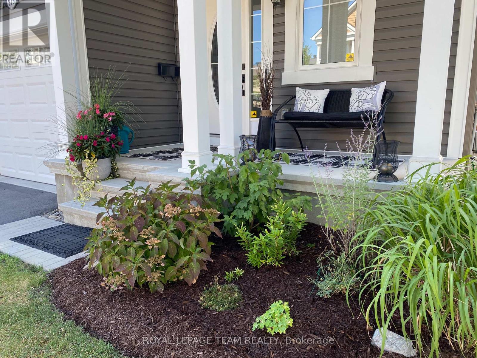 Summer 2025 photo of front covered porch - 979 Shimmerton Circle, Ottawa, ON - Outdoor With Deck Patio Veranda