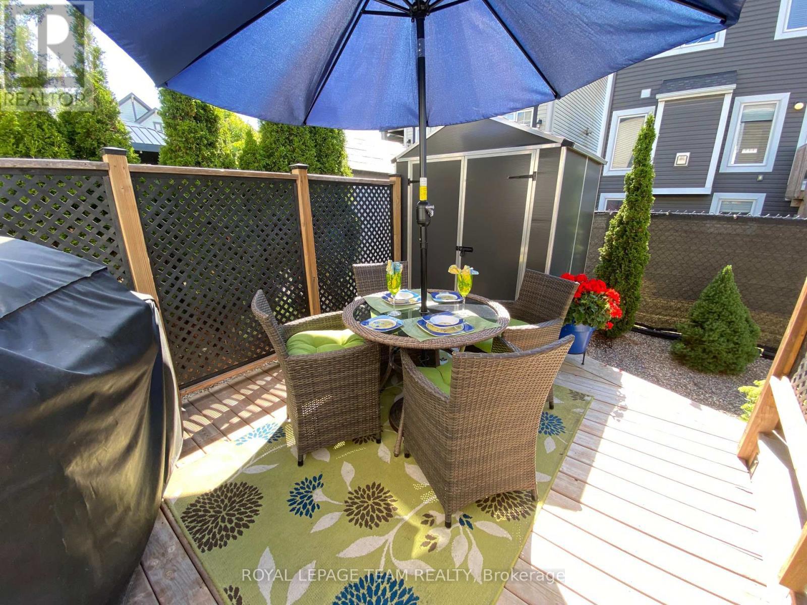 Summer 2025 photo Lower deck view of backyard shed - 979 Shimmerton Circle, Ottawa, ON - Outdoor With Deck Patio Veranda With Exterior