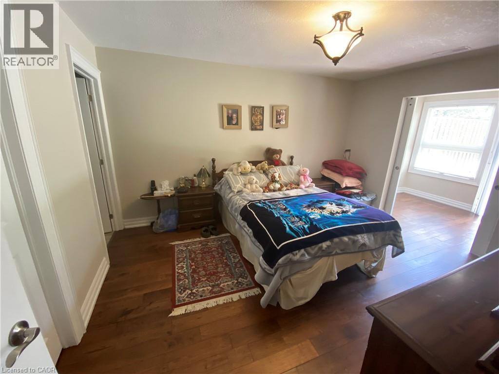 Bedroom with dark wood-type flooring - 36 Mckenna Court, Hamilton, ON - Indoor Photo Showing Bedroom