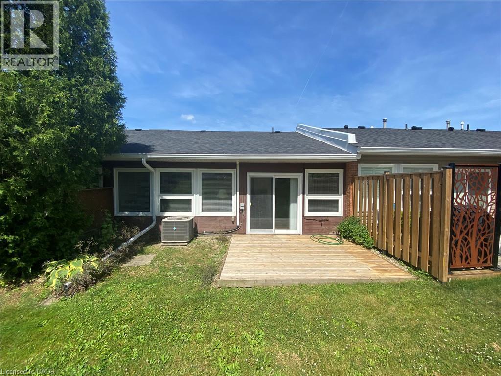 Back of house with roof with shingles, a wooden deck, and brick siding - 36 Mckenna Court, Hamilton, ON - Outdoor
