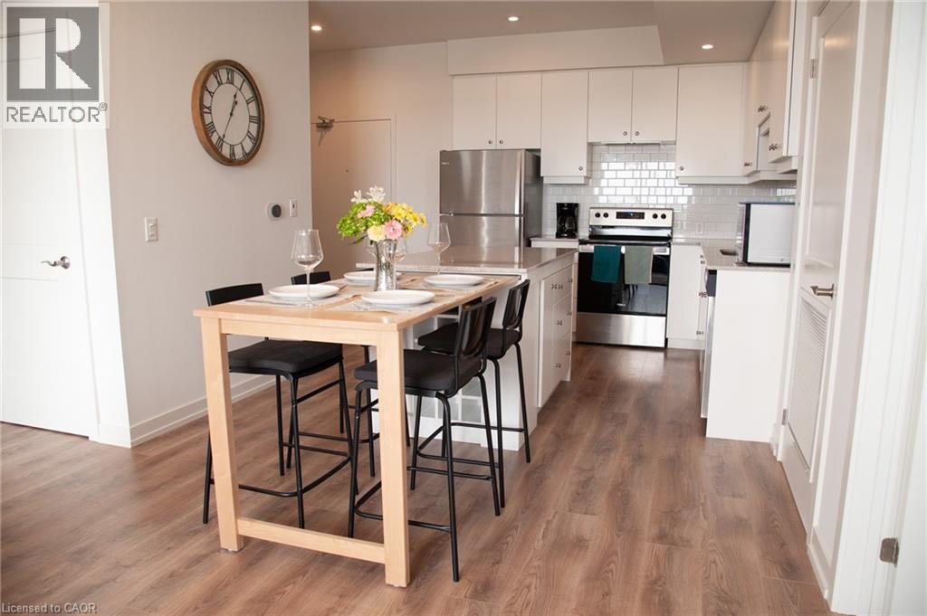 Extendable table that folds out from the island - 255 Northfield Drive E Unit# 506, Waterloo, ON - Indoor Photo Showing Kitchen With Stainless Steel Kitchen With Upgraded Kitchen