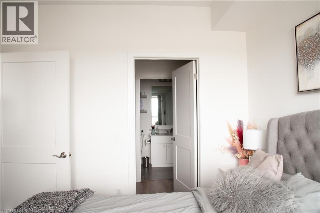 View of walk-in closet to the master bath - 255 Northfield Drive E Unit# 506, Waterloo, ON - Indoor Photo Showing Bedroom