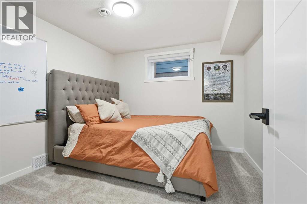 Lower level bedroom with access for upstairs - 711 101 Avenue Sw, Calgary, AB - Indoor Photo Showing Bedroom