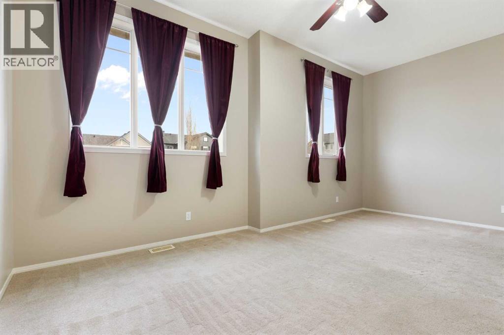 Bonus room, lots of light, ceiling fan, high ceiling, carpet floor - 129 Evansbrooke Way Nw, Calgary, AB - Indoor Photo Showing Other Room